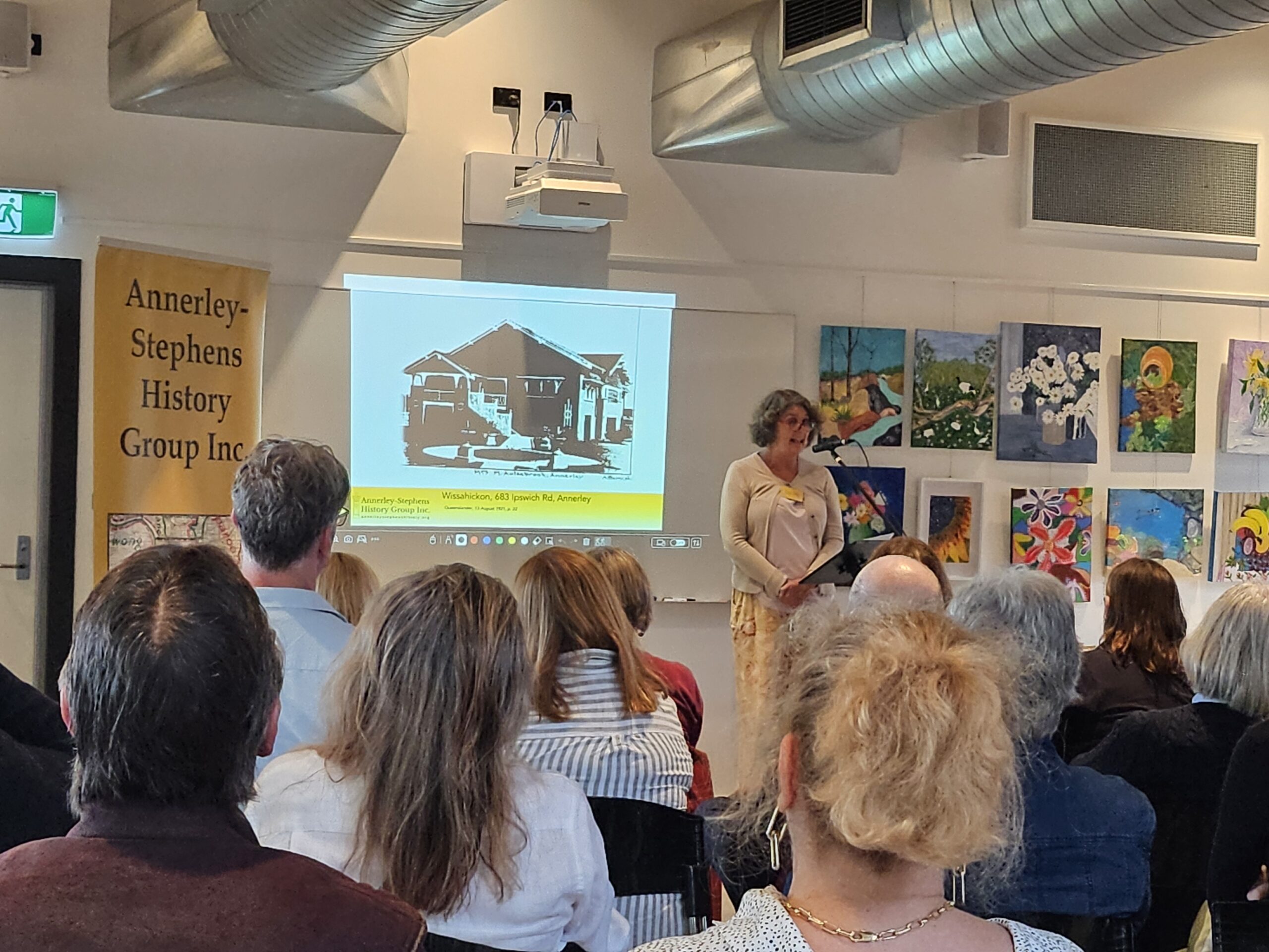 This is a photograph of Kate presenting her story about lost houses.